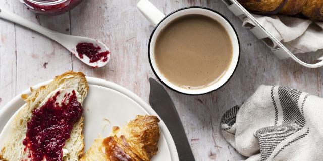 Breakfast set flat lay with croissant and raspberry jam food photography